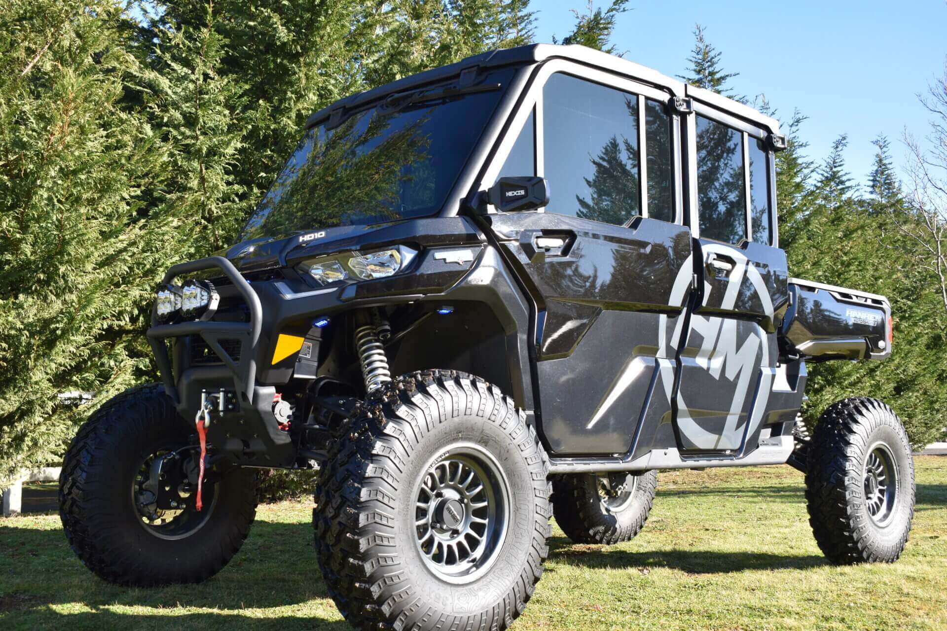 Black off-road utility vehicle on grass.