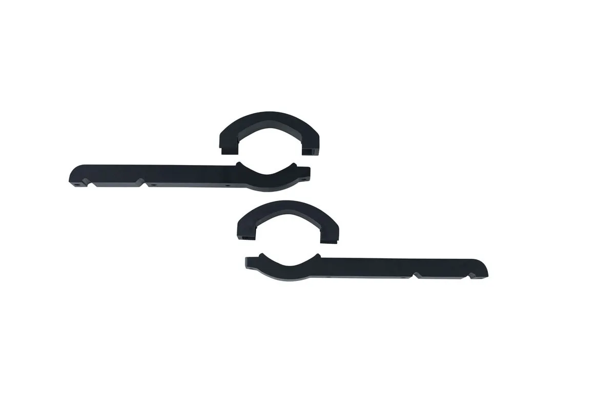 Black plastic bracket parts on white background.